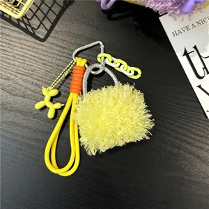Detailed macro view of vibrant yellow plush mini-bag keychain with a cute balloon dog charm