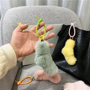 Detail of a cute candy-colored plush sock pendant with a flexible silicone twist-knot.