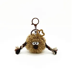 Detailed view of a quirky plush keychain featuring braids and a star charm for bags and backpacks