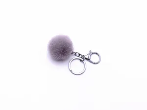 Detailed view of a soft purple plush pom pom keychain with silver keyring and clasp