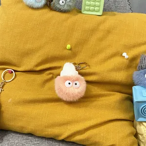 Cute fuzzy plush monster keychain with white knit hat and googly eyes.