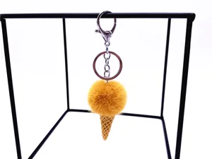 Detail of cute yellow ice cream cone plush keychain hanging on a display stand