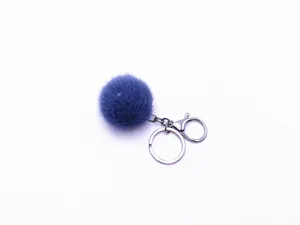 Detailed close-up view of a fluffy blue plush pom-pom keychain with a silver metal ring
