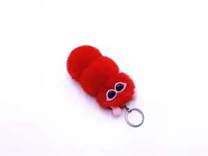 Detailed view of a cute red plush caterpillar keychain with pink glasses and ring