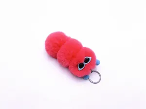 Close-up of pink fluffy caterpillar plush keychain with big eyes