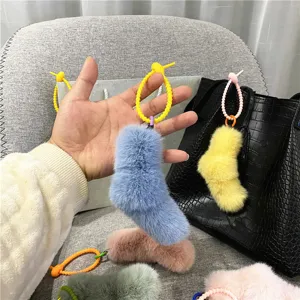 Close-up detail of cute candy-colored plush sock charms for bags and keychains.