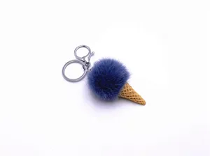Macro detail view of a cute blue plush ice cream cone keychain with a silver metal clasp.
