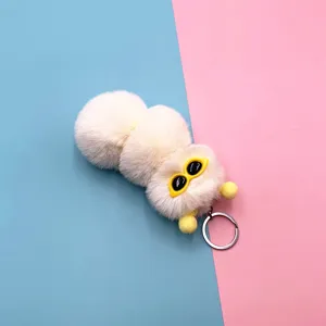 Cute white plush caterpillar keychain with yellow sunglasses on colorful background