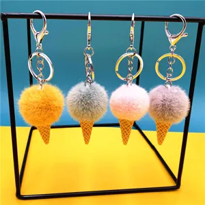 Cute ice cream cone plush keychains in four vibrant colors hanging on a metal display stand