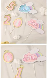 Close-up of pastel rainbow cloud and crown number shaker cake toppers with glitter