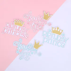 Set of pink and blue birthday cake toppers with golden crowns for prince and princess