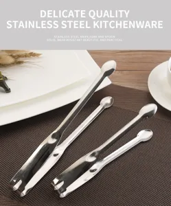 Close-up of stainless steel food tongs with serrated edges on a brown mat