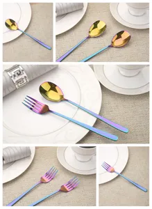 Detailed view of rainbow electroplated stainless steel fork and spoon on a white plate.