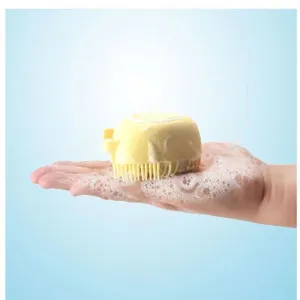 Silicone pet bath brush detail showing soft bristles and foam holding hand design.