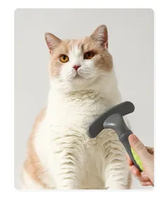 Close-up detail shot of a pet grooming brush with ergonomic handle used on cat hair.