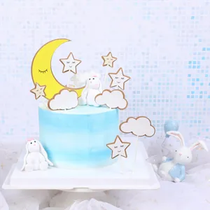 Detailed view of moon, star, and cloud cake toppers with cute rabbit figurines
