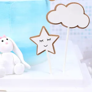 Close-up detail of cute star cake topper with smiley face and cloud design