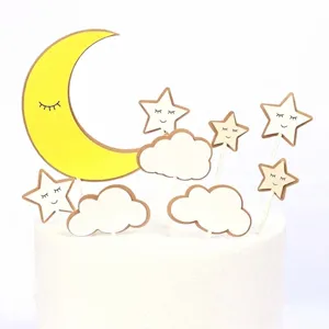 Close-up detail of moon and star cake toppers featuring cute sleeping face designs
