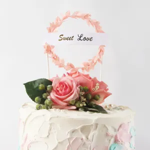 Detailed view of Sweet Love leaf wreath cake topper with artificial pink roses