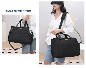 Portable black quilted pet carrier bag with adjustable shoulder strap for outdoor travel.