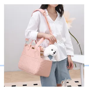 Portable pink pet carrier bag, breathable canvas shoulder crossbody bag for outdoor travel.