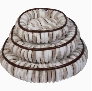 Detail view of nested round striped pet bed plush material with brown piping trim cozy design.