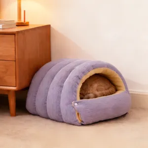 Cozy purple pet bed detail showing soft corduroy and warm interior lining with sleeping cat.