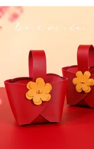 Elegant close-up view of a red leather wedding favor bag with a yellow flower decoration