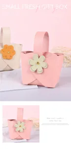 Detailed view of pink leather gift basket with flower ornament for wedding favors