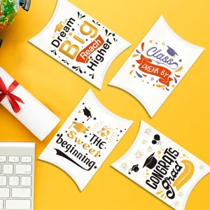 Detail of graduation theme pillow candy boxes with inspirational quotes on yellow background