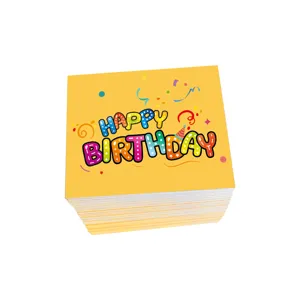 Detailed view of a stack of yellow Happy Birthday cards with colorful cartoon lettering