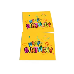 Close-up of two bright yellow birthday greeting cards with colorful Happy Birthday text