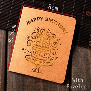 Close-up of creative kraft paper birthday card with laser-cut cake design and envelope