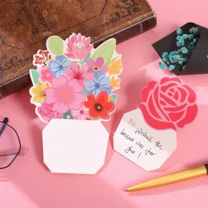 Close-up of 3D floral greeting card with handwritten heartfelt message on pink background