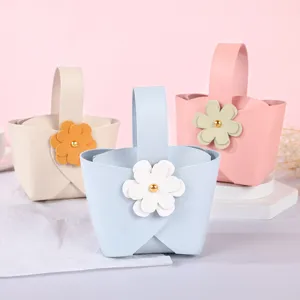 Elegant handheld leather candy gift boxes with floral accents for wedding guest favors
