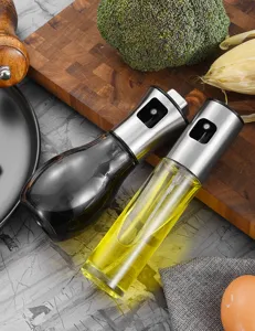 Close-up detail of stainless steel glass oil sprayer bottles for kitchen cooking and BBQ
