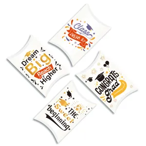 Four white graduation pillow gift boxes with various inspirational printed designs