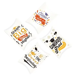 Detailed view of graduation themed pillow candy boxes with inspirational quotes