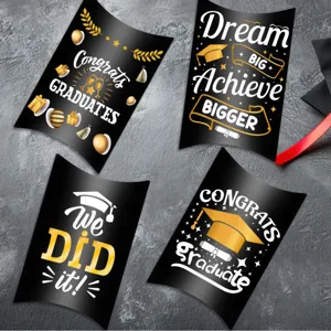 Detailed macro view of black graduation candy boxes with gold and white festive prints
