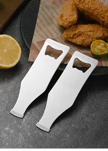 Close-up of wine bottle shaped stainless steel bottle openers on a rustic food setting