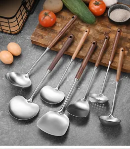 Close-up detail of 304 stainless steel kitchen utensil set with ergonomic wooden handles