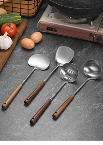 304 stainless steel kitchen utensil set with ergonomic wooden handles in a kitchen scene.