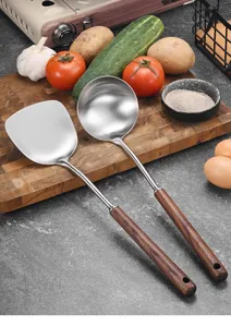 Stainless steel ladle and spatula set with ergonomic wooden handles in a kitchen setting
