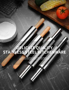 Variety of professional stainless steel rolling pins with wooden handles in kitchen.