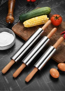 Detail shot of stainless steel rolling pins with ergonomic wooden handles.
