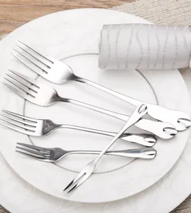 Detailed macro shot of mirror-polished stainless steel forks with water drop handles