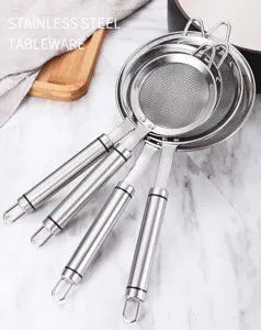 Detail view of four stacked stainless steel mesh strainers with hanging loops on handles