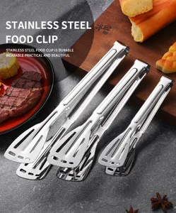 Detailed view of stainless steel food tongs in three sizes on a rustic wooden board