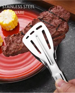 Detailed view of stainless steel food tongs gripping a grilled steak on a red plate