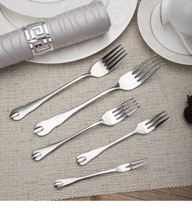 Detailed view of various sized teardrop series stainless steel forks with mirror finish.